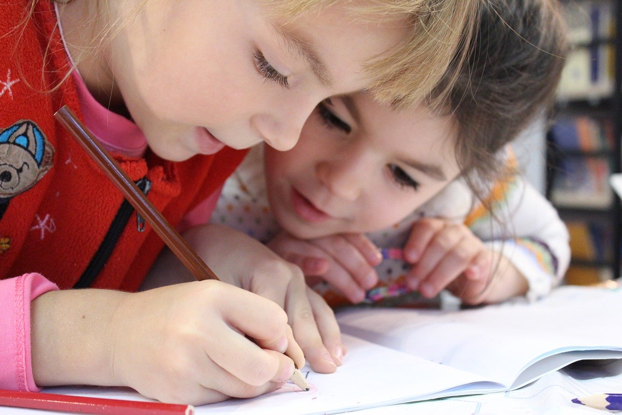 2 Children Coloring a Book